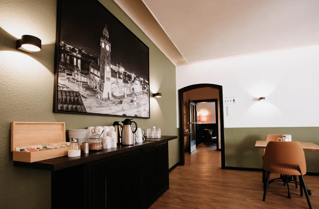 Breakfast room with serving counter at Arcade Hostel Hamburg